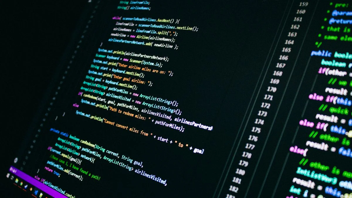 Close-up of colorful programming code on a dark computer screen